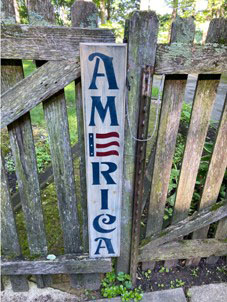 Wooden stenciled sign that says America