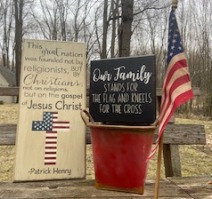 Two wooden patriotic signs with flag and bucket