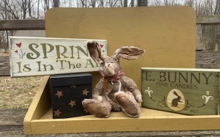 Two wooden stenciled signs and an primitive stuffed rabbit