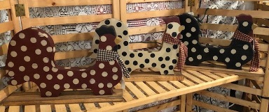 three wooden chickens in barn red with ivory polka dots, ivory with black polka dots, and black with ivory polka dots